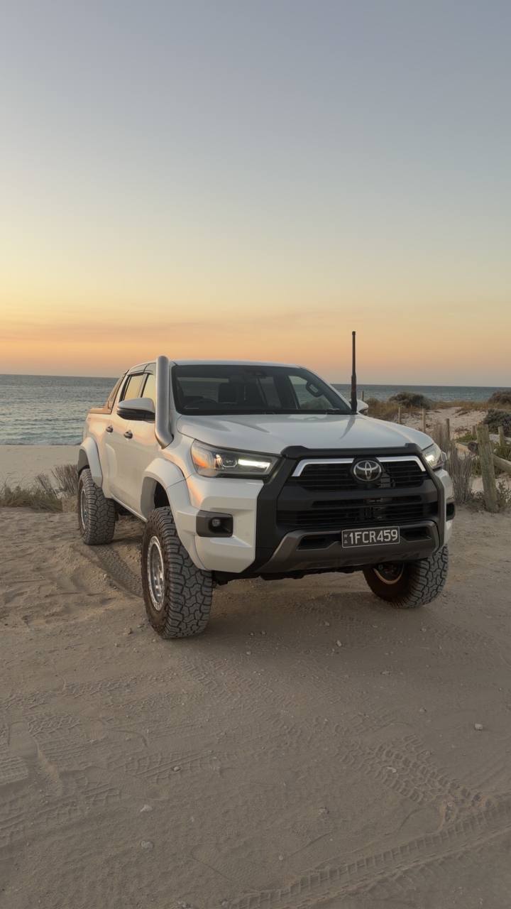 White HiLux beach sunset